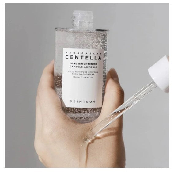A 30ml glass dropper bottle of SKIN1004 Madagascar Centella Tone Brightening Capsule Ampoule, designed to fade dark spots, hydrate, and calm sensitive skin.